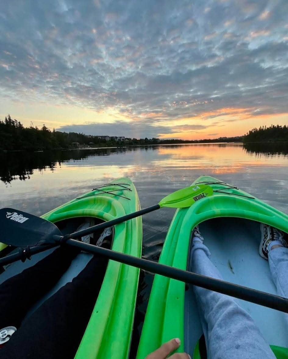 A Paradise Paddles kayak on Neil's Pond at sunset.