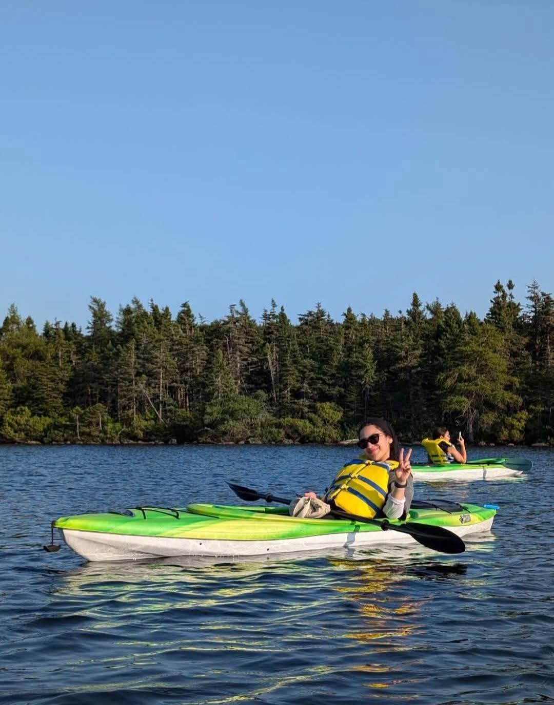 Kayaks and paddles on the water at Neil's Pond.